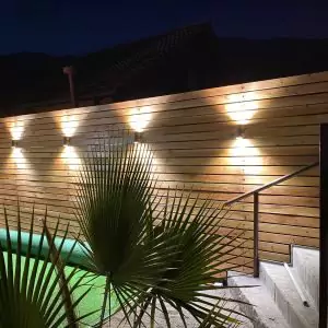 Una valla de madera iluminada por varias luces
